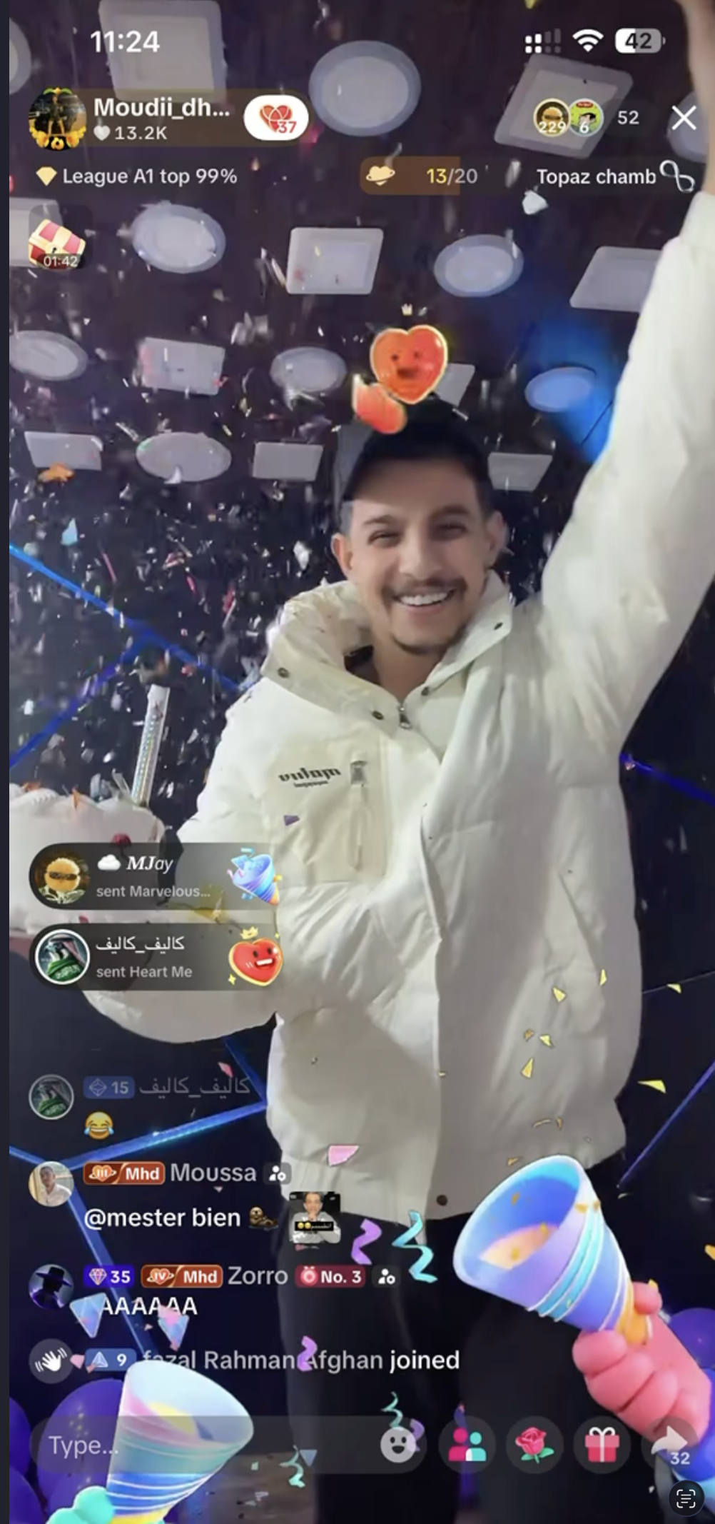 Moudi Dhainy celebrating on TikTok LIVE with confetti